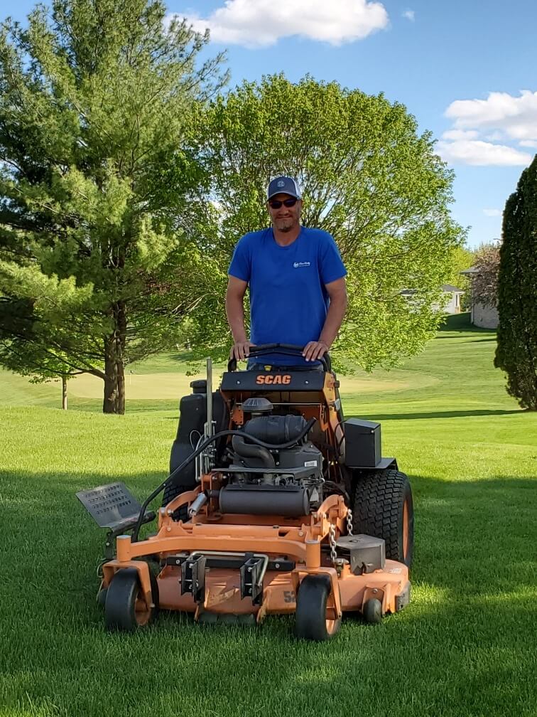 Jay White mowing a customer's lawn